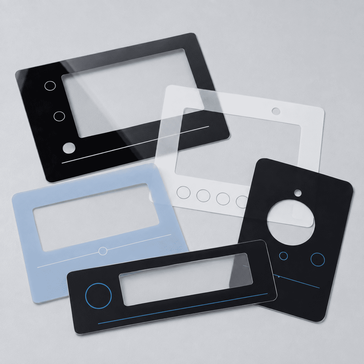 Five printed graphic overlays fanned out in black, white, clear and pale blue